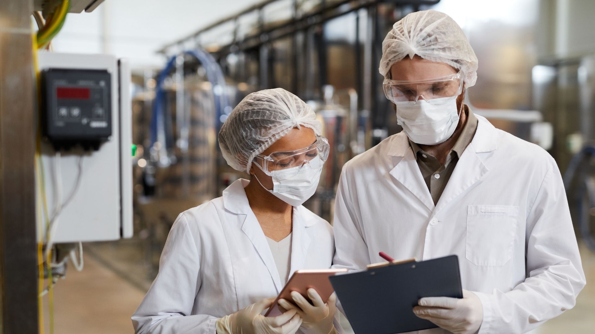 Vrouw en man inspecteren de fabriek